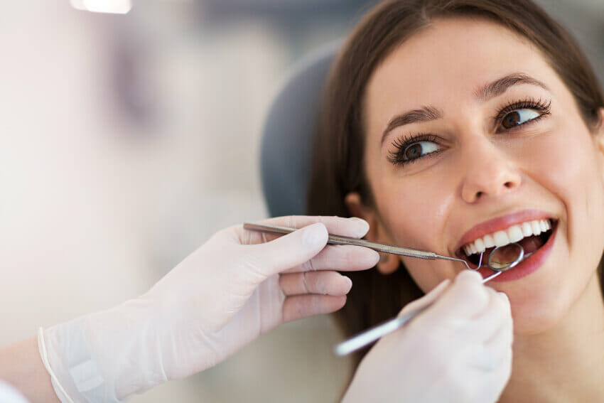Woman in dentist chair receiving crown lengthening