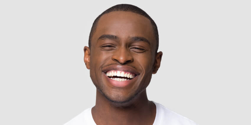 Man smiling after visiting dentist