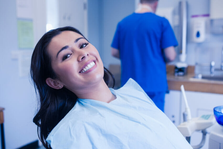 Woman sitting in dental chair at her first dental visit